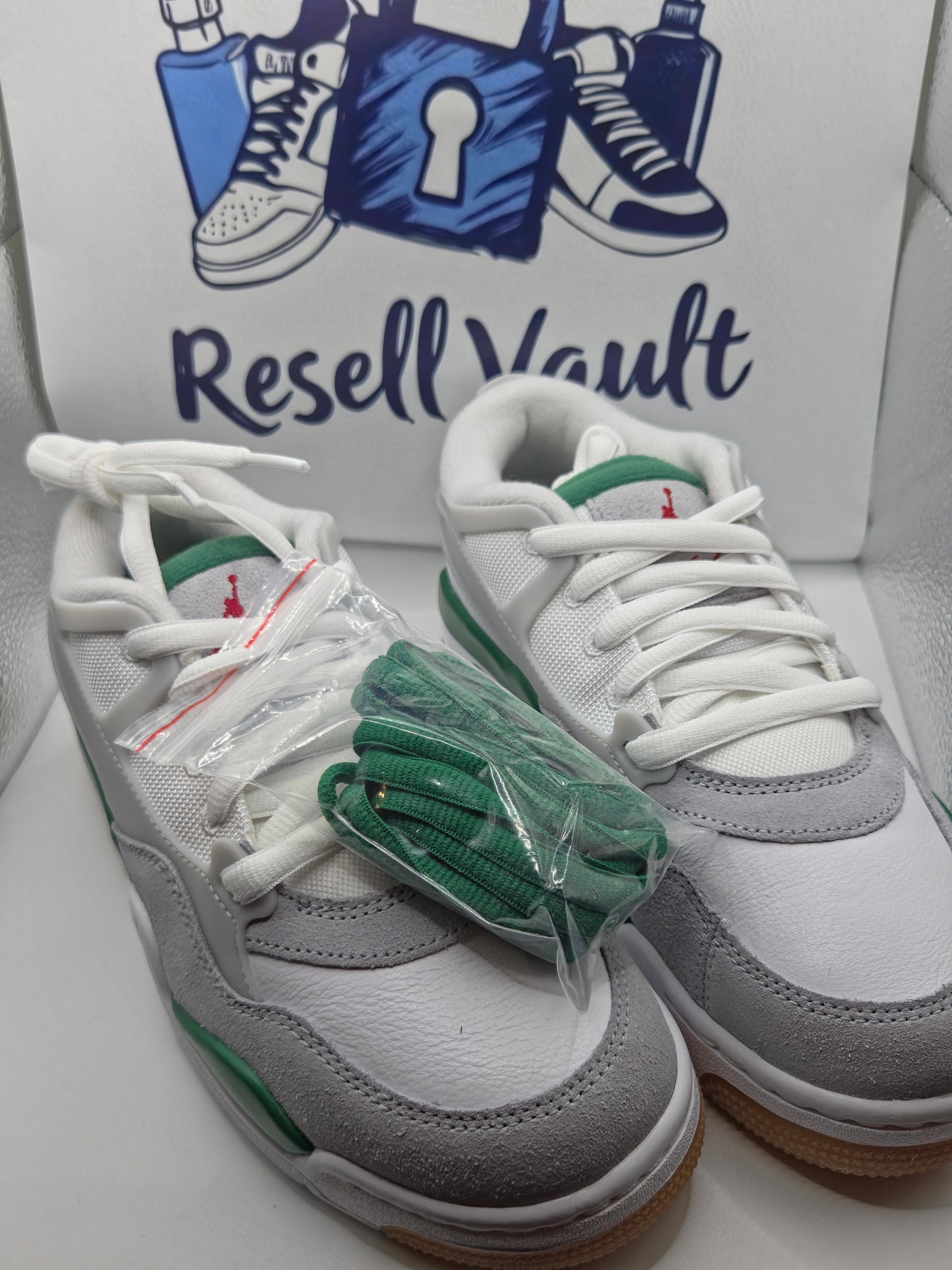 Jordan Air 4 RM sneakers in a White, Pine Green, and Neutral Grey